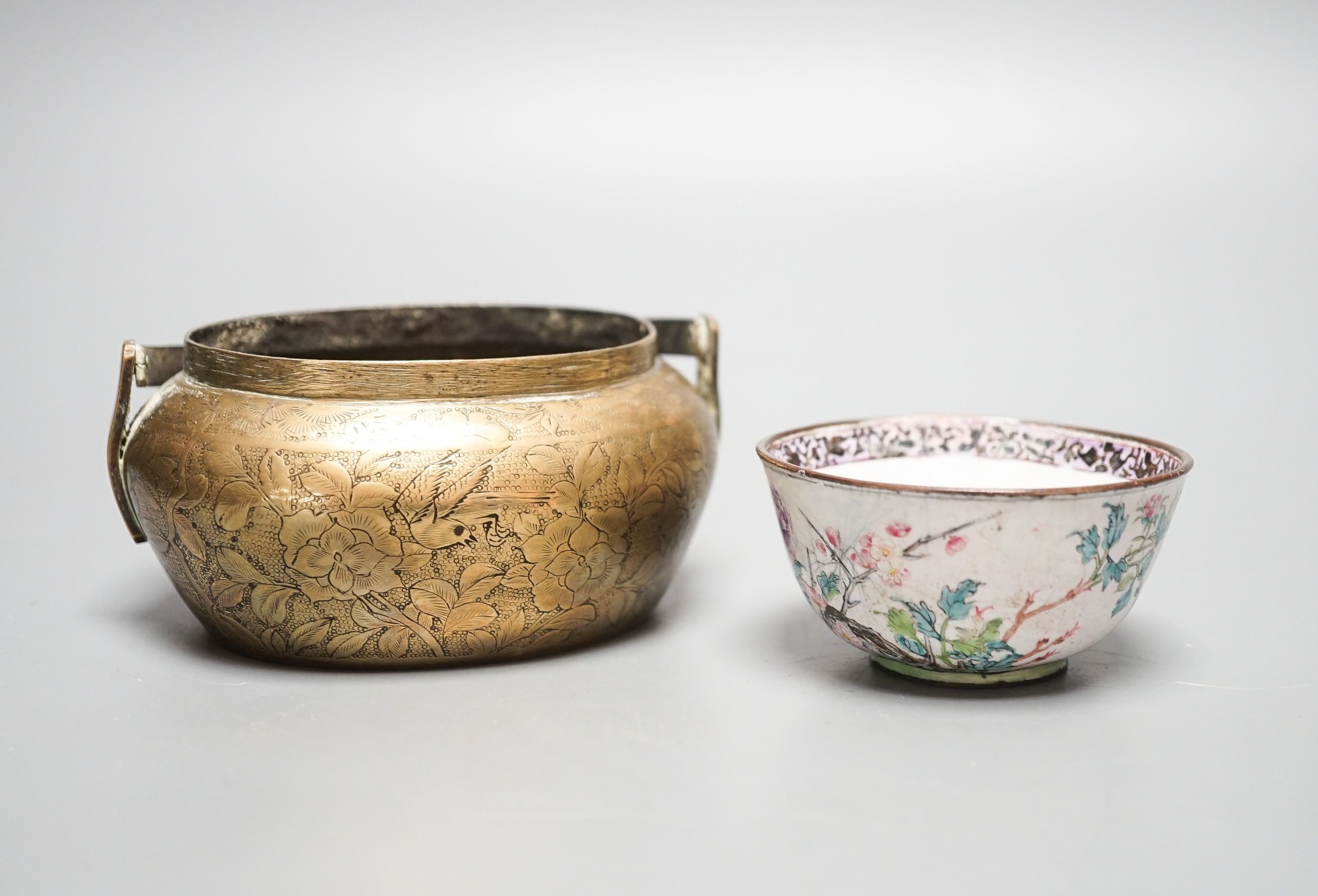A Chinese bronze hand warmer, 11.3cm and an 18th century Chinese Canton enamel cup
